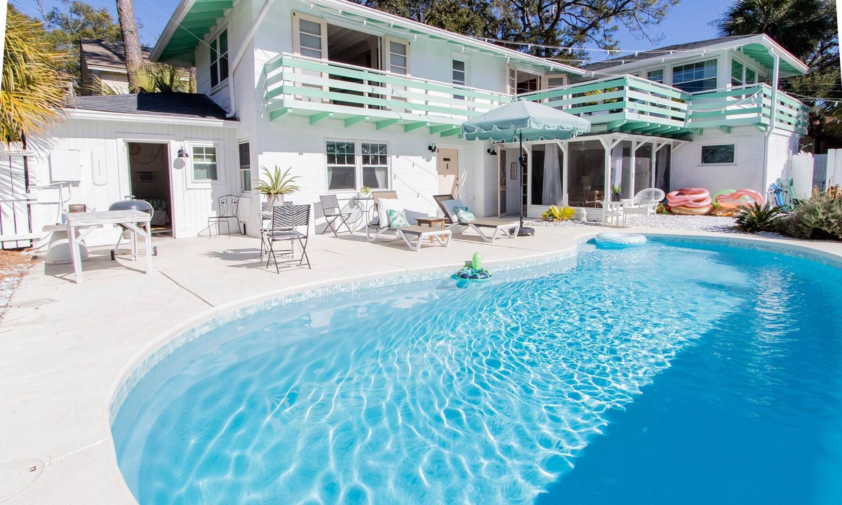 Savannah Beach Cottage | Poolside Tiki bar with swings! Heated pool! See boardwalk to beach from lawn!