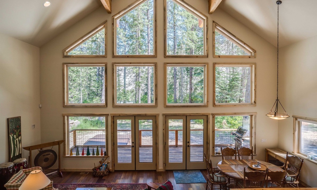 Plain House | Riverfront cabin with a hot tub & fireplace.