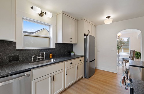 Camas House | Charming Camas home with 3 bedrooms and a shared bath, just minutes from downtown. Relax by the fireplace, enjoy a bright living space, and cook in the updated kitchen. A comfortable spot for families or small groups visiting Camas, WA.