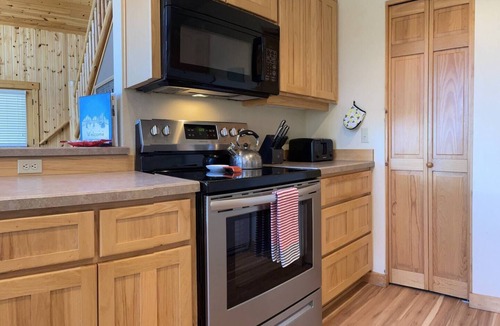 Redmond Ski Chalet | Cozy knotty pine chalet with creekside deck, BBQ, and access to pools, hot tubs, gym, golf, hiking.