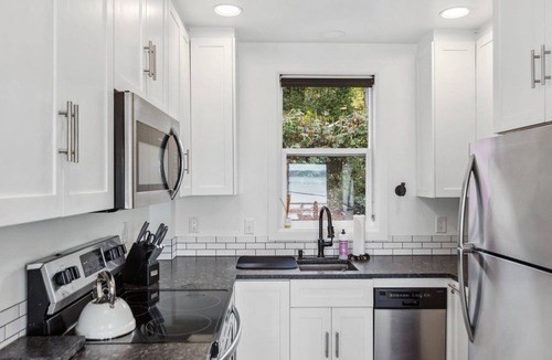 Camano Island House | Darling pink beach house with epic views in a cozy community.