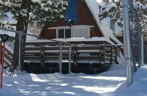 Woodlands Ski Chalet | Knotty Pine Chalet has a huge front deck and fully fenced yard .