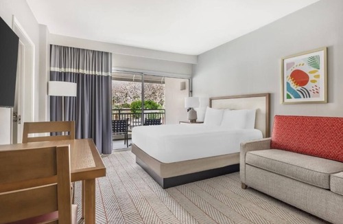 Canyon Corridor Hotel | Relax with Stunning Pool Views from Your Private Balcony in This Modern Suite