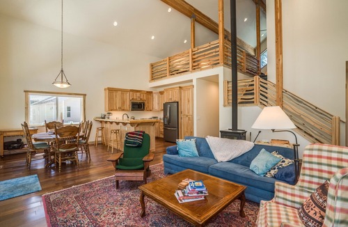 Plain House | Riverfront cabin with a hot tub & fireplace.