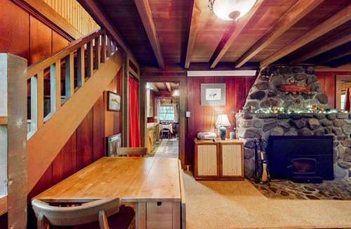 Marmot Apartment | Unwind in nature's embrace at a 1925 cabin with hot tub & river views