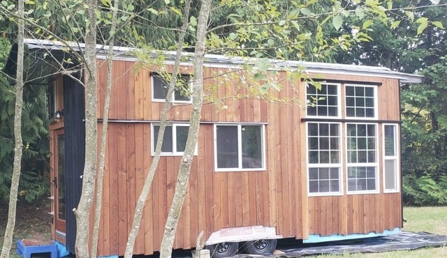 High end tiny home with tons of light, exposes serene views of mature forests.